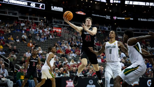 Cincinnati Bearcats guard Simas Lukosius (41) hits a layup around Baylor Bears forward Jalen Bridges (11) in the second half of the Big 12 Conference tournament game between Cincinnati Bearcats and Baylor Bears at T-Mobile Center in Kansas City, Mo., on Thursday, March 14, 2024.